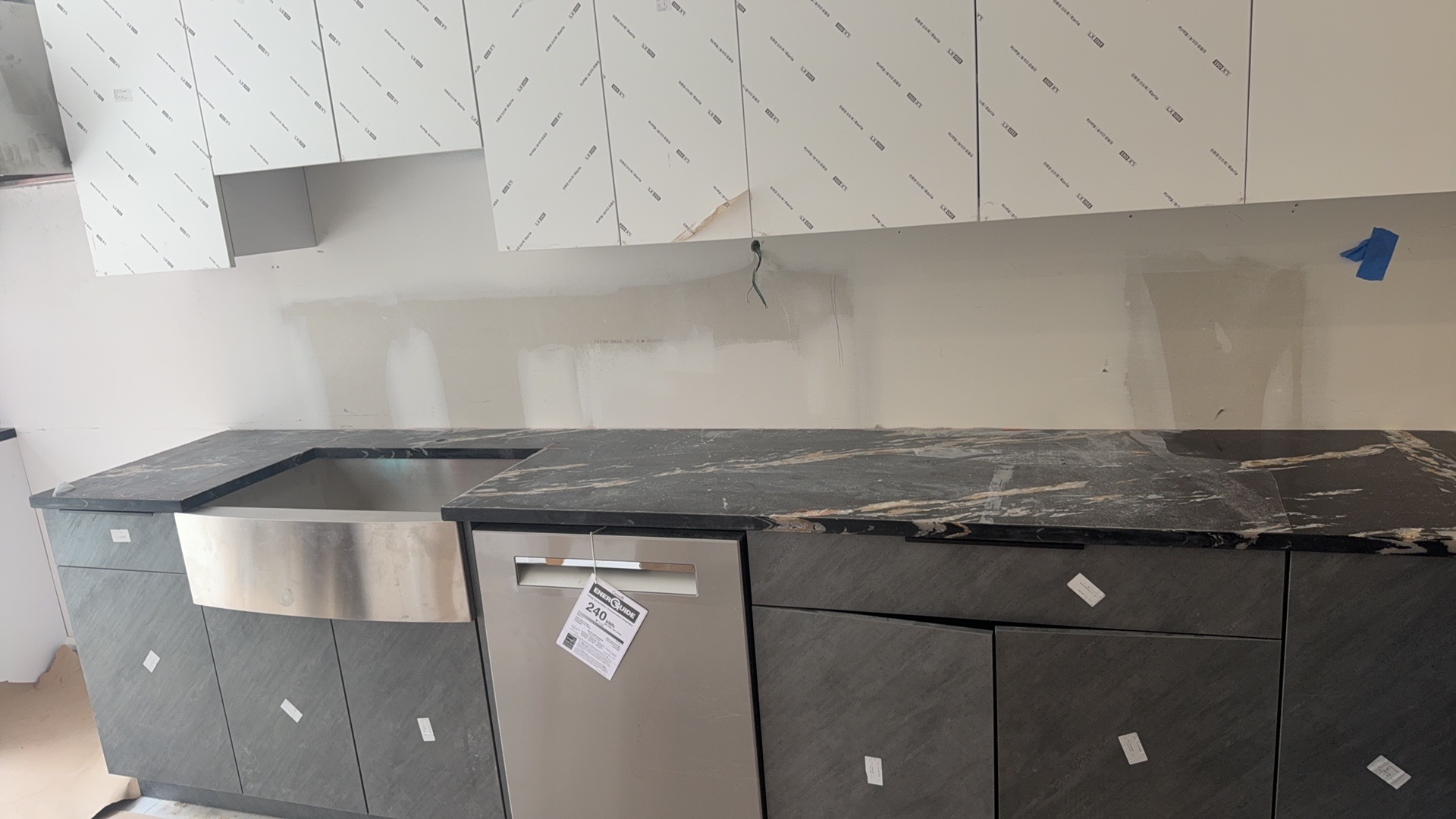 Graphite Stone sample 338 used on textured gray lower cabinets with black marble-look countertops during installation
