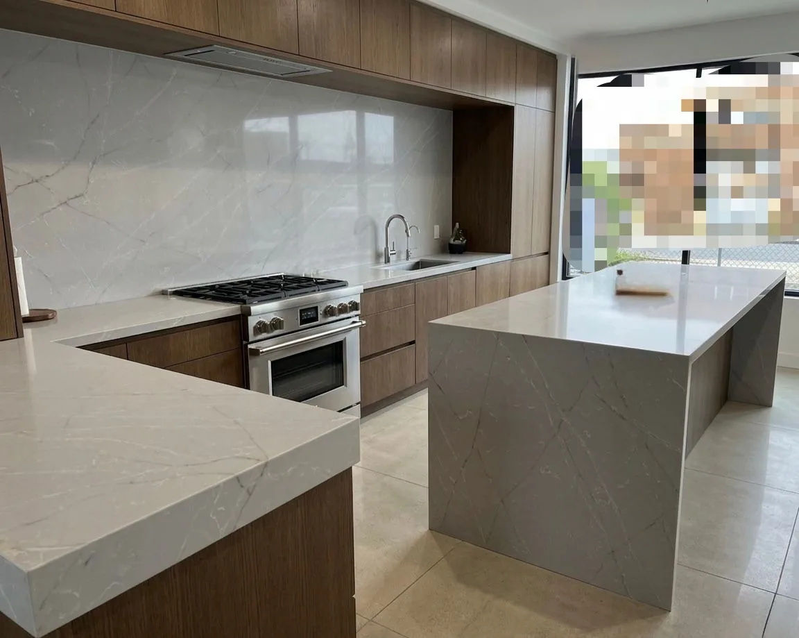 Contemporary wood kitchen with a waterfall stone island and full-height stone backsplash